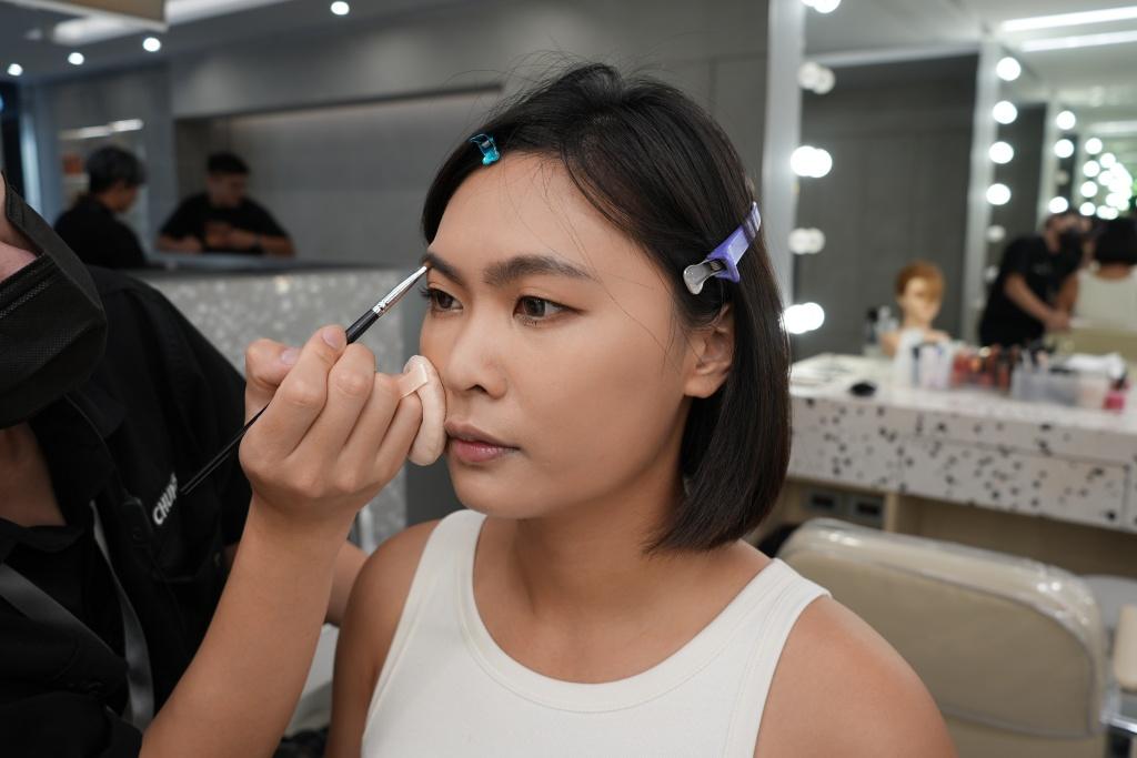 Full makeup and hair, with eyes that look bigger and brighter.