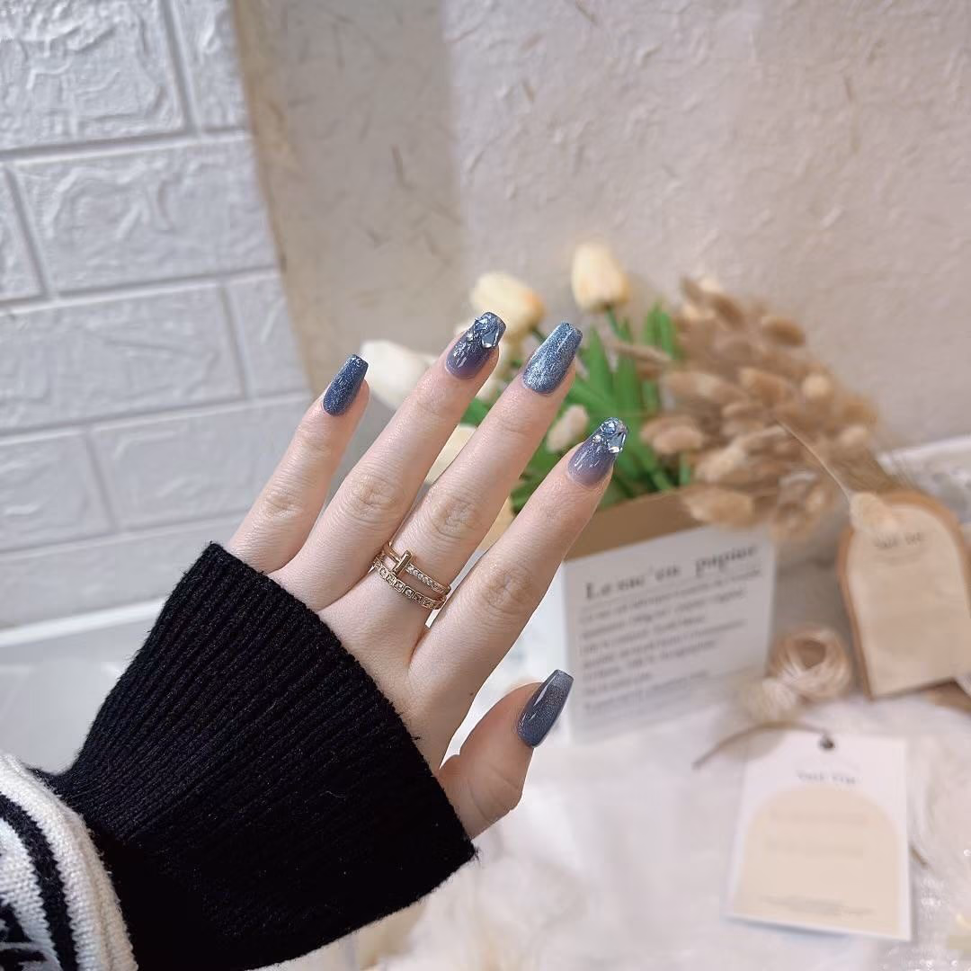 Darker nail colors like deep red, navy blue, and forest green can make your hand